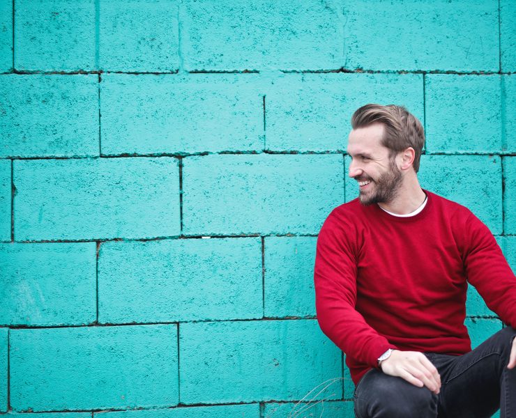 man smiling sitting casually