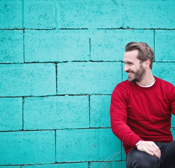man smiling sitting casually